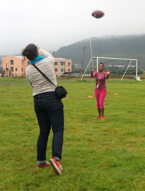 Some Goal 2 - teaching the girls how to throw an American football
