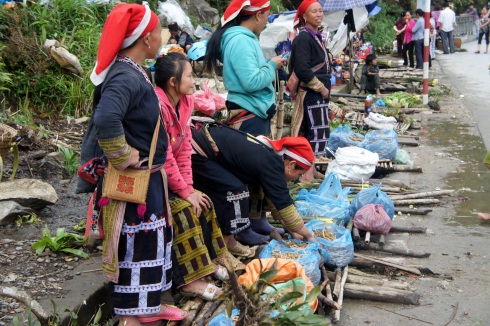 Red Dzao women near Thac Bac Waterfall. They wear red head pieces.